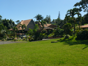 Broad lawns extend from the intriguing complex to the lakeside forest.